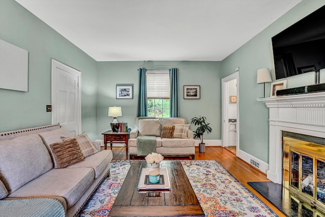 2408 Avenham Ave SW, Roanoke, VA 24014 - living room with wood finished floors, a glass covered fireplace, and baseboards