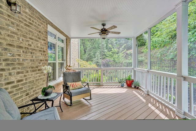 wooden deck featuring a ceiling fan