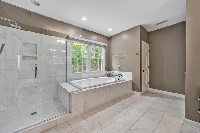 bathroom with marble finish floors, a bath, tiled shower, baseboards, and recessed lighting