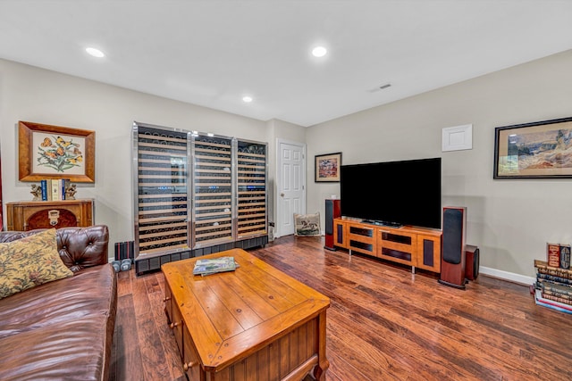 living area with wood finished floors, recessed lighting, and baseboards