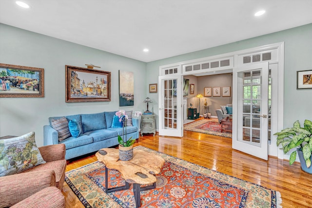 living area featuring french doors, wood finished floors, recessed lighting, and baseboards