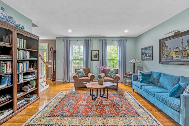 living room with stairway, wood finished floors, and recessed lighting