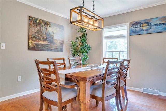 414 Mallard Cove Rd, Moneta, VA 24121 - dining area with light wood-type flooring, a chandelier, ornamental molding, and baseboards