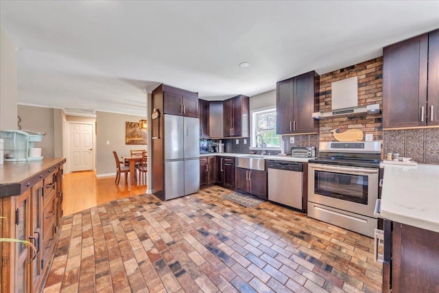 414 Mallard Cove Rd, Moneta, VA 24121 - kitchen with appliances with stainless steel finishes, dark brown cabinetry, brick floors, a sink, and light countertops