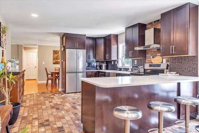 414 Mallard Cove Rd, Moneta, VA 24121 - kitchen with appliances with stainless steel finishes, decorative backsplash, a kitchen breakfast bar, light countertops, and recessed lighting