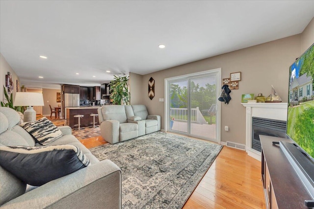 414 Mallard Cove Rd, Moneta, VA 24121 - living area with recessed lighting, a glass covered fireplace, light wood finished floors, and baseboards