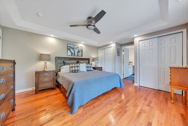 414 Mallard Cove Rd, Moneta, VA 24121 - bedroom featuring a raised ceiling, two closets, light wood-style flooring, baseboards, and recessed lighting