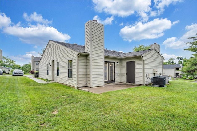 7204 Snowberry Cir, Roanoke, VA 24019 - back of house featuring a chimney, central air condition unit, a lawn, and a patio area