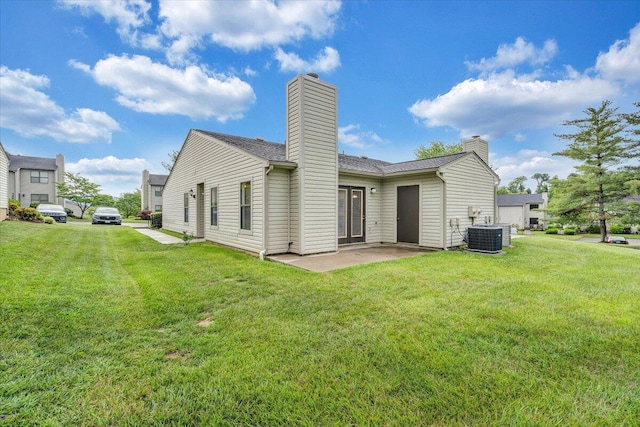 7204 Snowberry Cir, Roanoke, VA 24019 - rear view of house featuring a chimney, a lawn, a patio area, and cooling unit