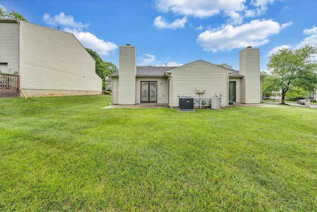7204 Snowberry Cir, Roanoke, VA 24019 - rear view of house with central air condition unit, french doors, a yard, and a chimney