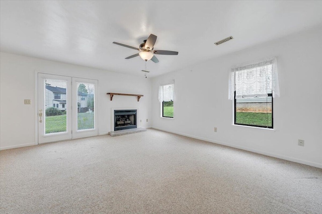7204 Snowberry Cir, Roanoke, VA 24019 - unfurnished living room featuring carpet flooring, a fireplace with raised hearth, a ceiling fan, and baseboards