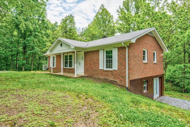 ranch-style house featuring an attached garage, brick siding, driveway, a porch, and a front lawn