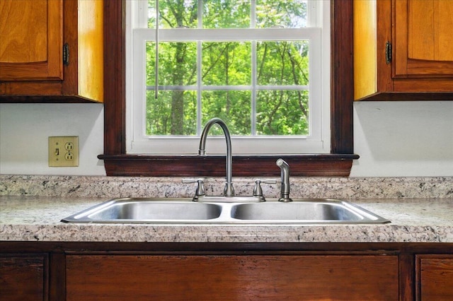 66 Adrian St, Bassett, VA 24055 - kitchen featuring a sink, light countertops, and brown cabinetry