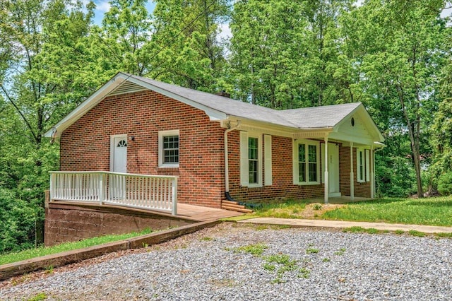 view of front facade with brick siding and a porch