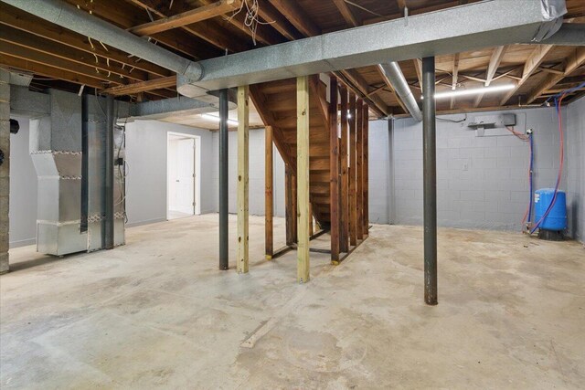 66 Adrian St, Bassett, VA 24055 - unfinished basement with a water pressure tank, heating unit, stairway, and concrete block wall