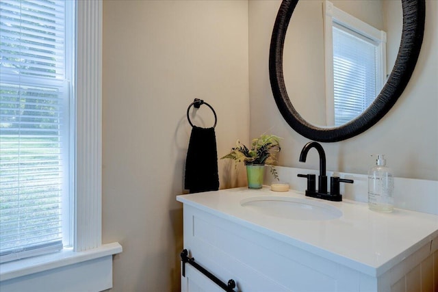 bathroom with plenty of natural light and vanity