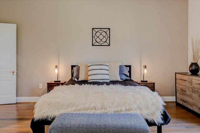 bedroom featuring baseboards and wood finished floors