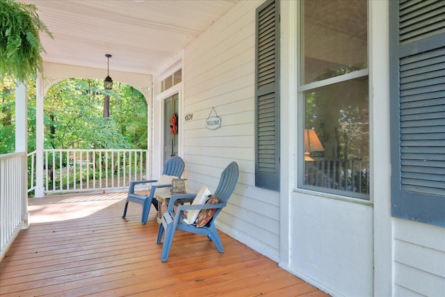 wooden terrace featuring covered porch