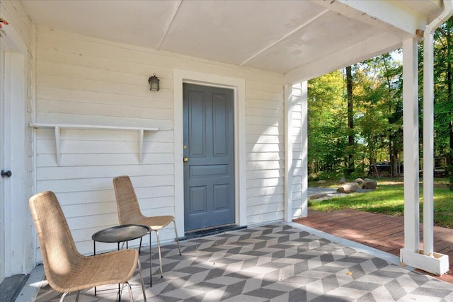view of exterior entry featuring a wooden deck