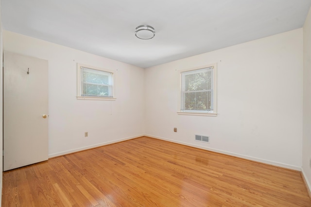 spare room with light wood-type flooring and baseboards