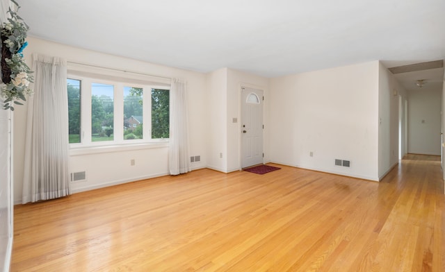 unfurnished living room featuring light wood finished floors and baseboards