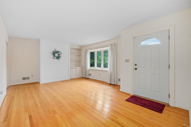 entrance foyer with light wood-type flooring and baseboards