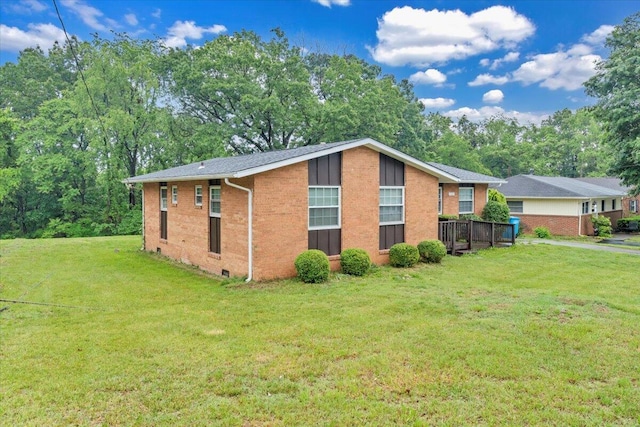 view of property exterior featuring brick siding and a yard