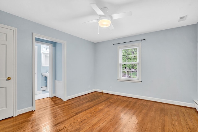 2848 Longview Ave SW, Roanoke, VA 24014 - spare room with wood finished floors, ceiling fan, and baseboards