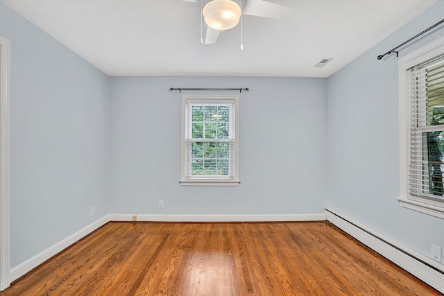 2848 Longview Ave SW, Roanoke, VA 24014 - empty room featuring a baseboard heating unit, wood finished floors, a ceiling fan, and baseboards