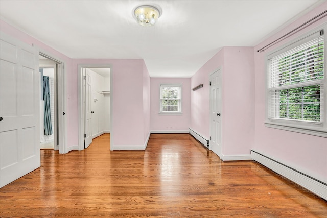 2848 Longview Ave SW, Roanoke, VA 24014 - spare room with baseboard heating, a baseboard radiator, light wood finished floors, and baseboards