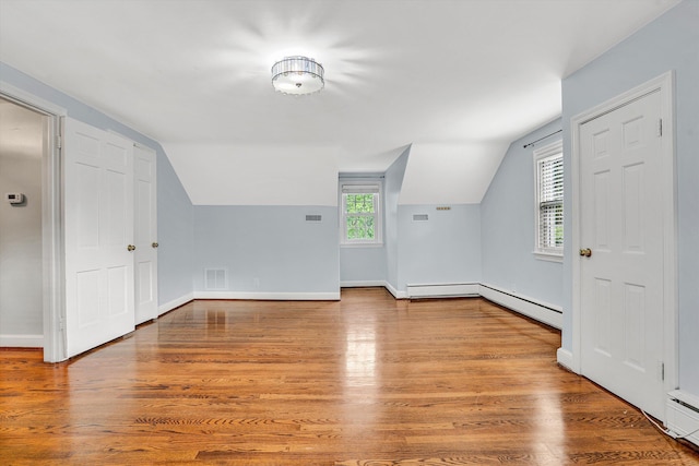 2848 Longview Ave SW, Roanoke, VA 24014 - bonus room featuring a baseboard heating unit, lofted ceiling, wood finished floors, baseboards, and baseboard heating