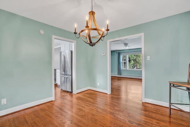 2848 Longview Ave SW, Roanoke, VA 24014 - empty room with a chandelier, wood finished floors, a baseboard radiator, baseboards, and a smoke detector