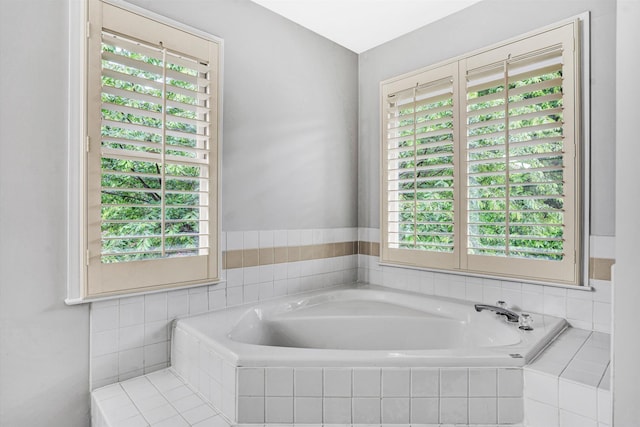 bathroom featuring plenty of natural light and a bath