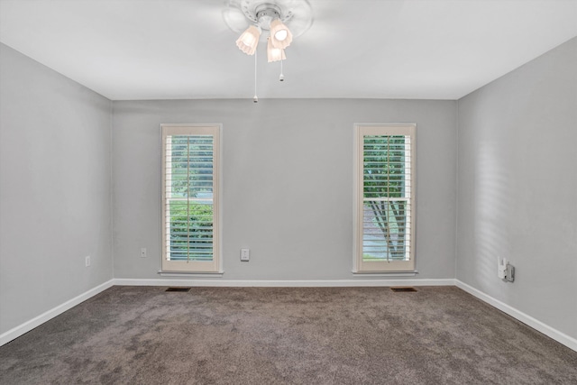 unfurnished room with carpet floors, a ceiling fan, and baseboards