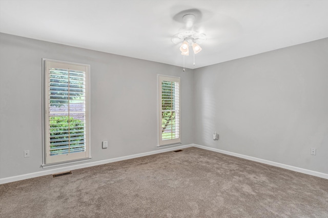 spare room featuring carpet flooring, a ceiling fan, and baseboards