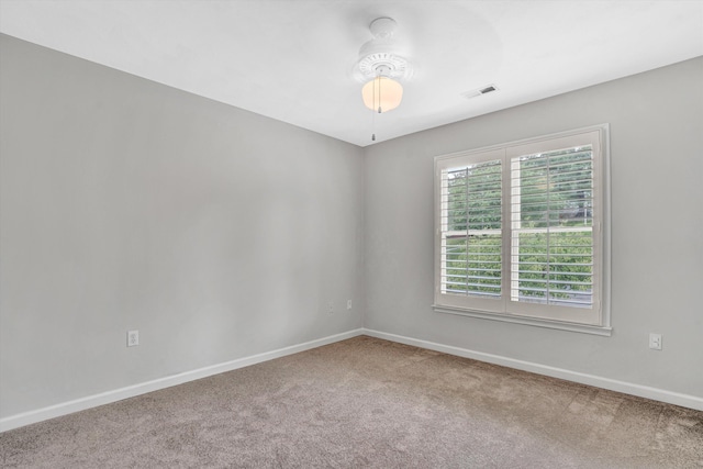 spare room featuring carpet floors, baseboards, and ceiling fan