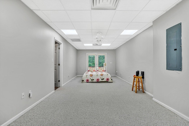bedroom with electric panel, carpet, a paneled ceiling, and baseboards