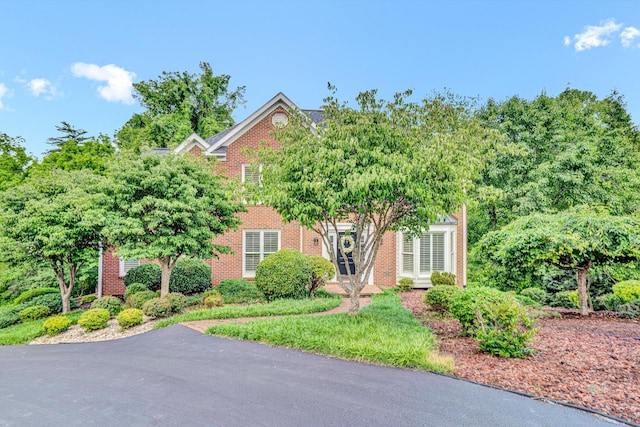 obstructed view of property with brick siding