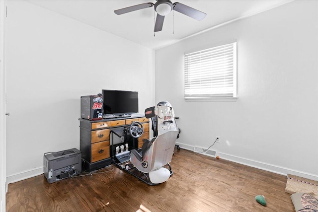 office area with wood finished floors, a ceiling fan, and baseboards