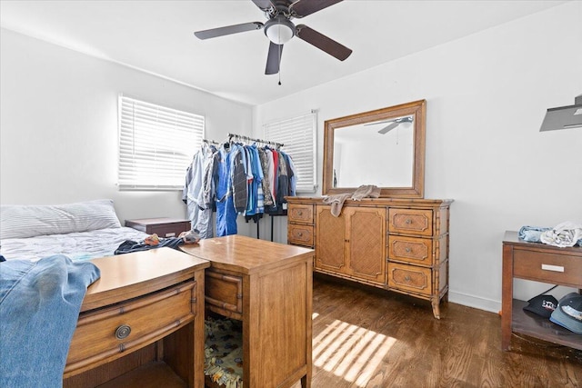 bedroom featuring dark wood-type flooring, a ceiling fan, and baseboards