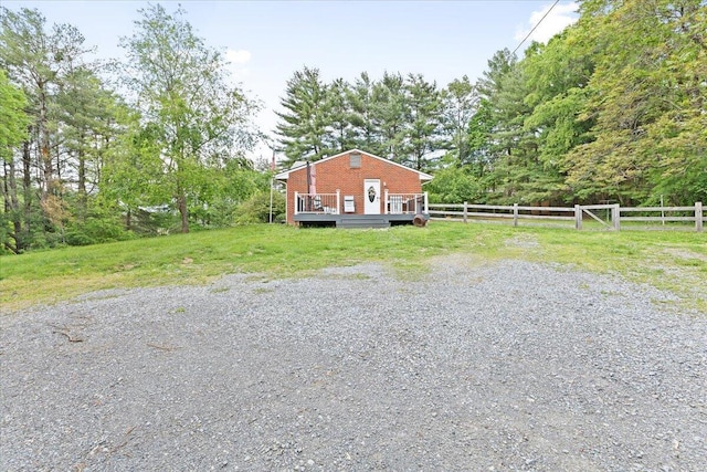 view of home's exterior with a wooden deck and fence