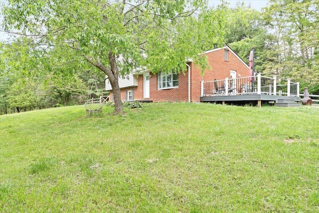 view of grassy yard featuring a deck