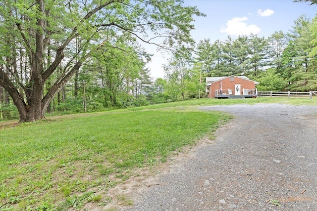 view of yard with dirt driveway