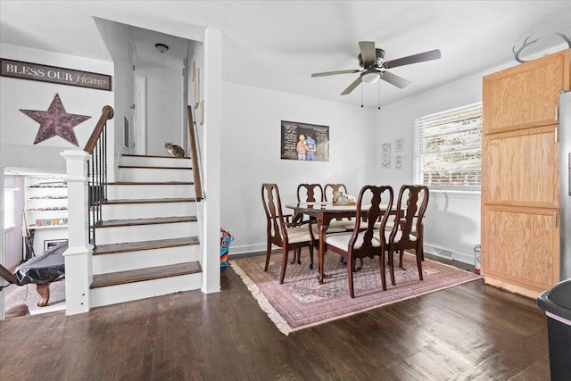 dining space featuring a ceiling fan, dark wood-style floors, stairway, and baseboards
