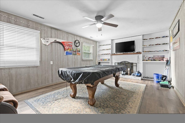 recreation room with wood finished floors, a ceiling fan, pool table, baseboards, and wooden walls
