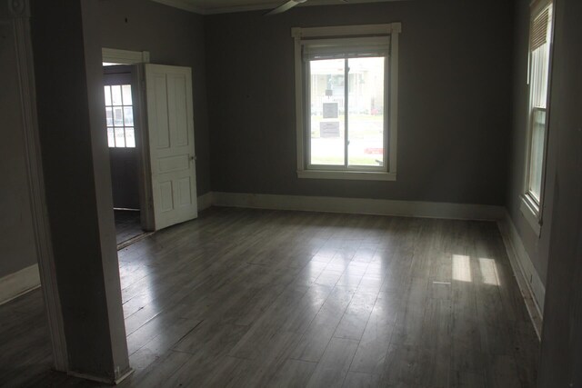 705 Rose Ave, Clifton Forge, VA 24422 - empty room with healthy amount of natural light, wood finished floors, baseboards, and ornamental molding