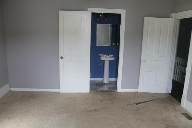 705 Rose Ave, Clifton Forge, VA 24422 - unfurnished bedroom featuring baseboards and ensuite bathroom