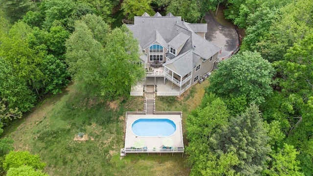 view of subject property with a pool