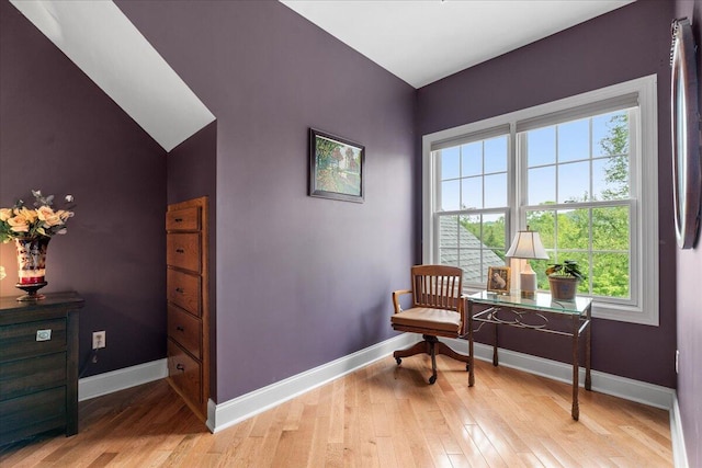 sitting room with baseboards and light wood-style flooring