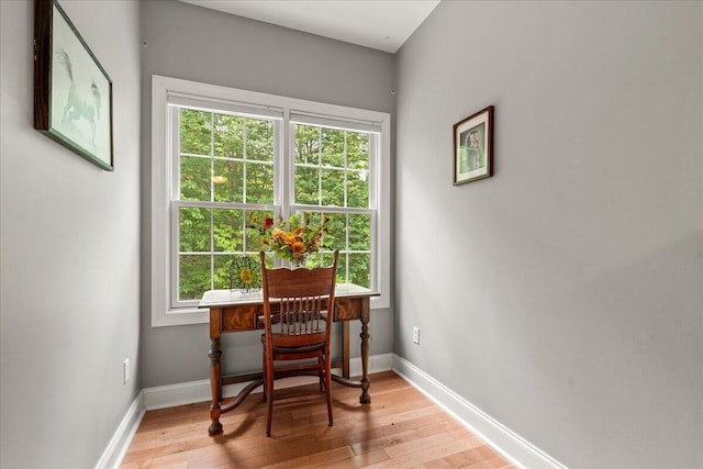 office area featuring healthy amount of natural light, light wood-style flooring, and baseboards